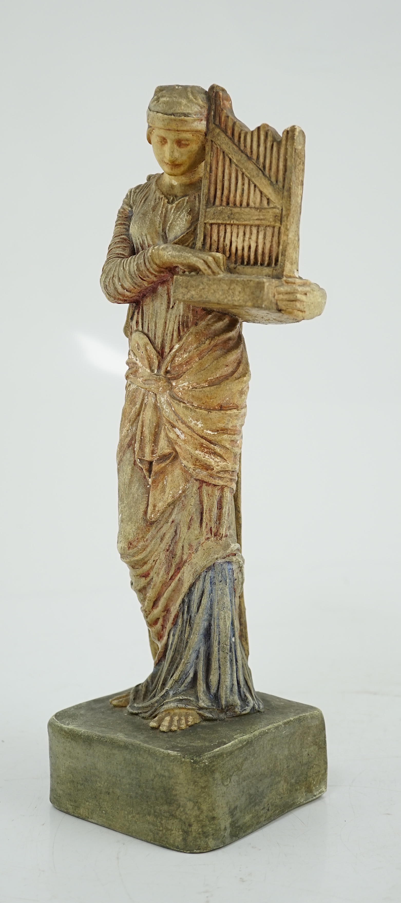 A Compton tempera painted pottery figure of St Cecilia, early 20th century, losses to paint